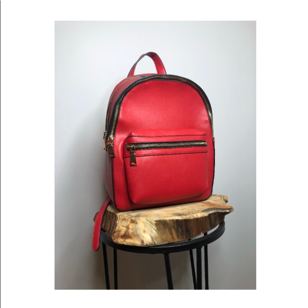 Charming Charlie Faux Red Leather Backpack.